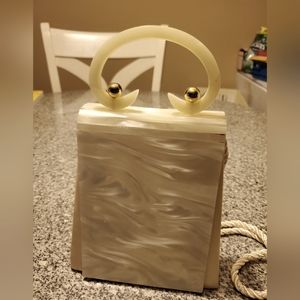 Off white ivory purse with long strap.